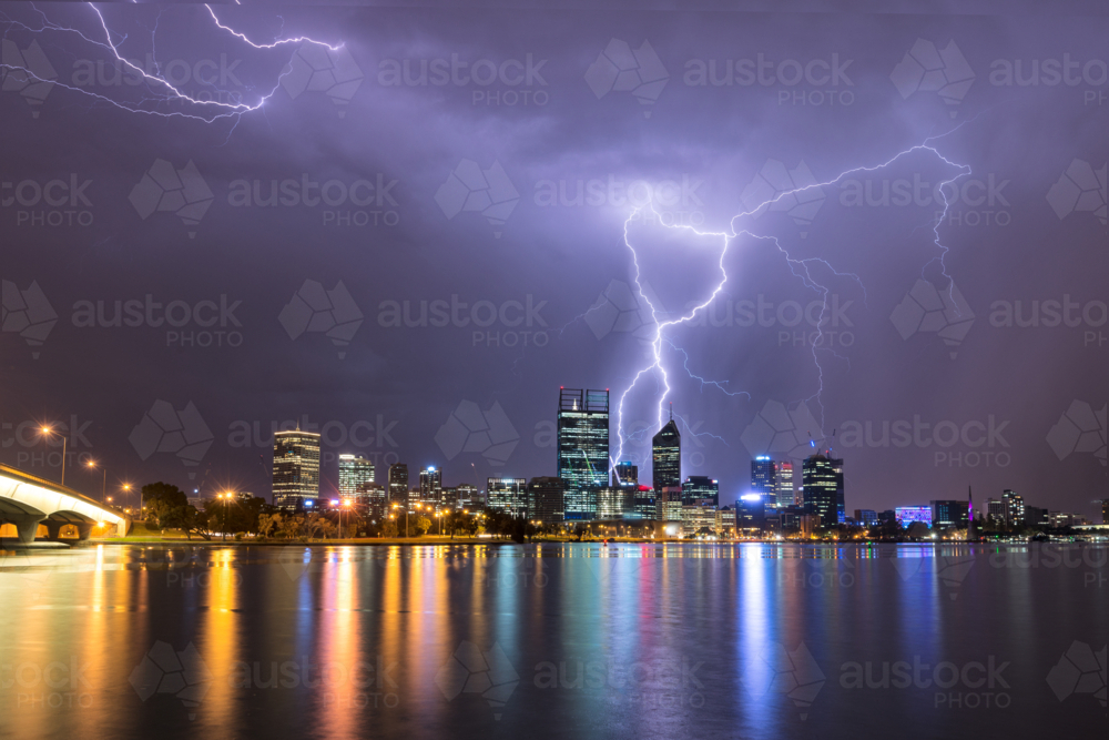 Lightning Over Perth City And Swan River with lights reflected in water - Australian Stock Image