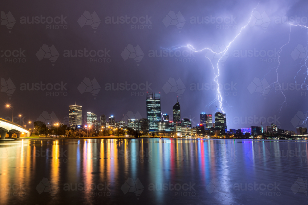 Lightning Over Perth City And Swan River with lights reflected in water - Australian Stock Image