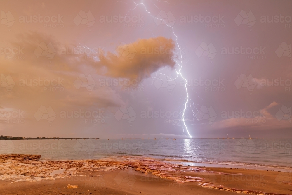 Lightning strike over Fannie Bay during sunrise - Australian Stock Image