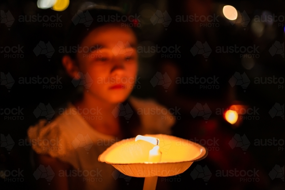 Image of lit candle at an outdoor carols by candlelight event