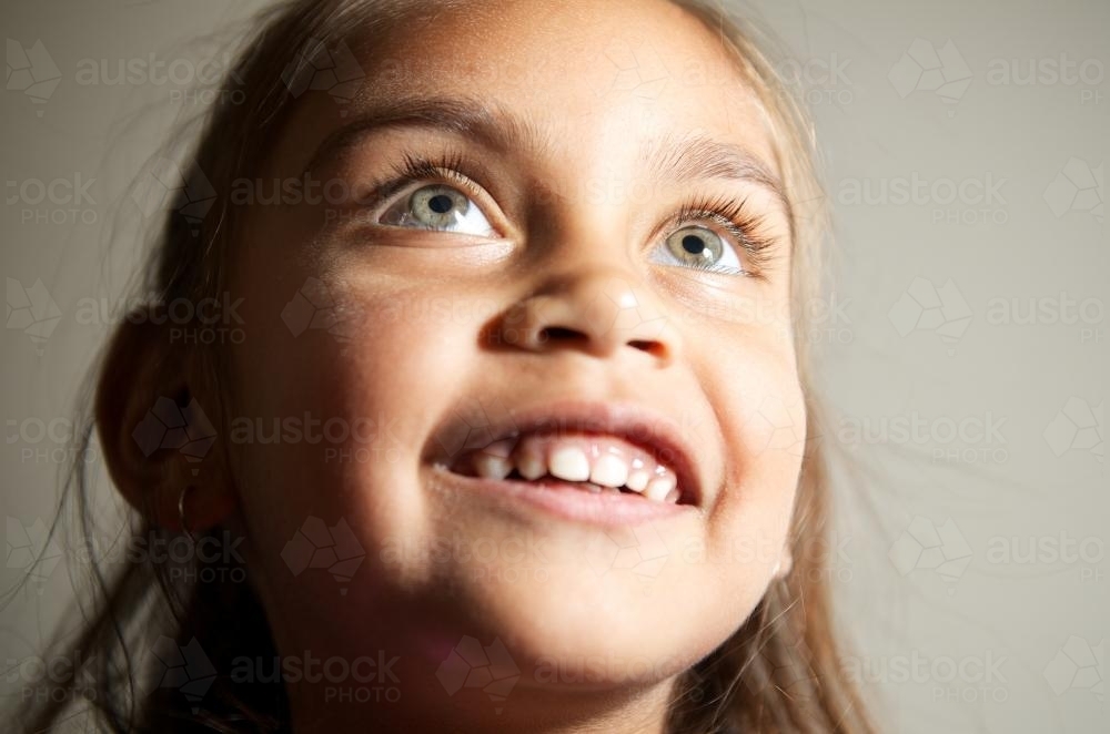Little Aboriginal Girl Looking Upwards - Australian Stock Image