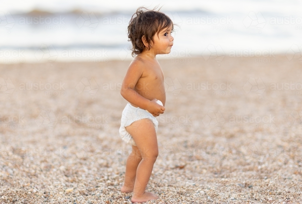 image-of-little-aboriginal-toddler-wearing-only-a-nappy-on-the-beach