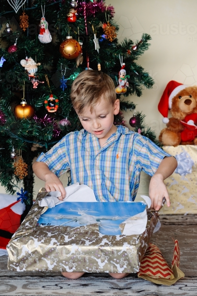 Little boy opening a drone on Christmas day - Australian Stock Image