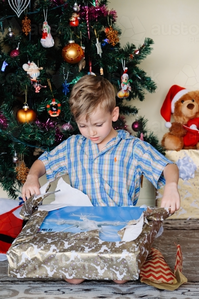 Little boy opening a drone on Christmas day - Australian Stock Image