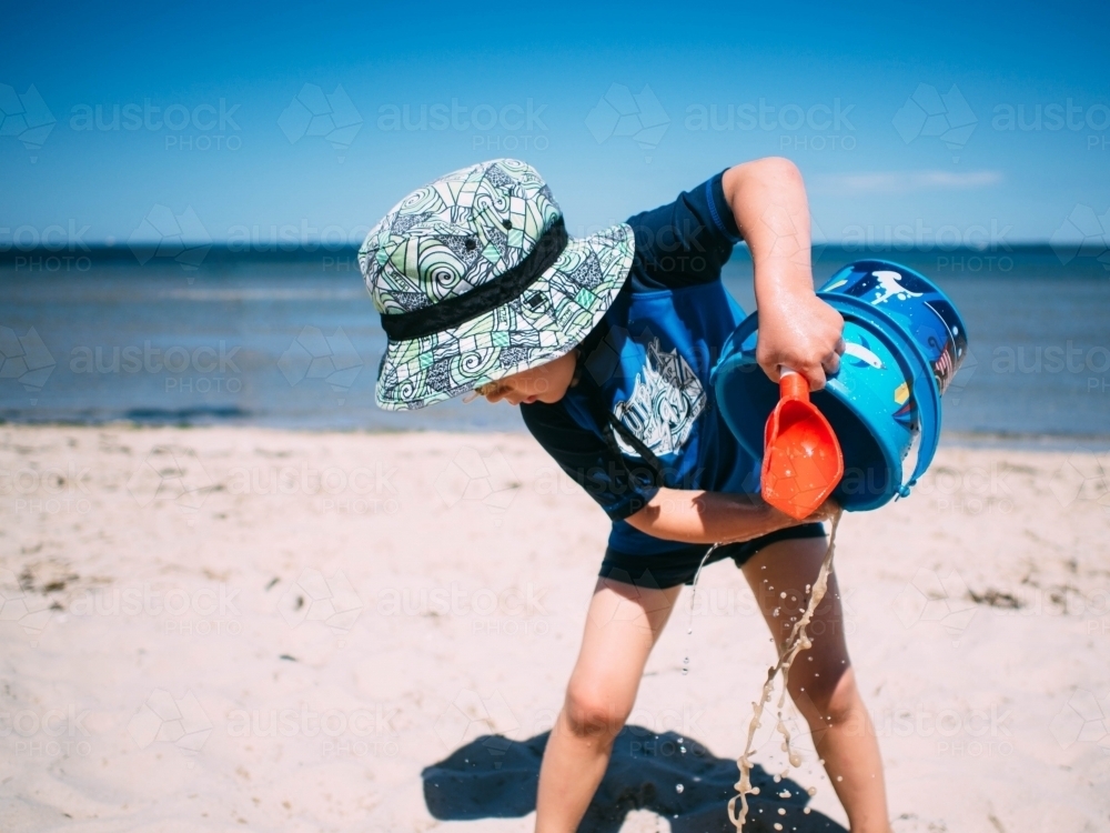 Little boy playing at the beach - Australian Stock Image
