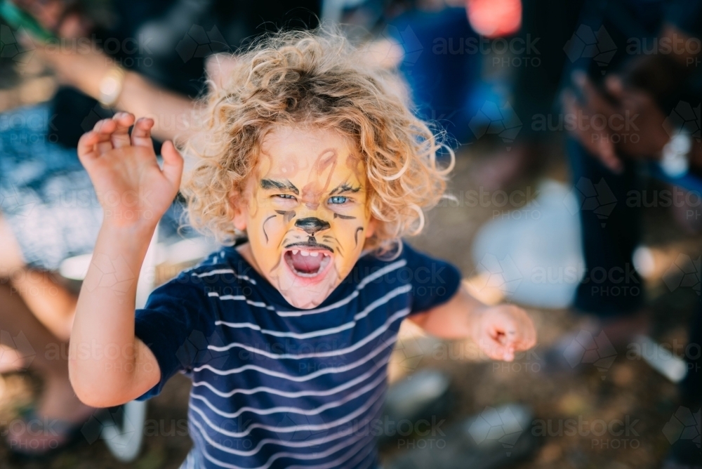Little boy roaring with face paint - Australian Stock Image