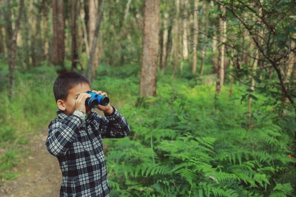 Little boy using binoculars - Australian Stock Image
