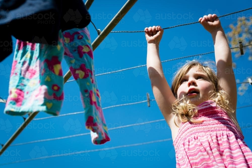 Little girl at the clothesline - Australian Stock Image