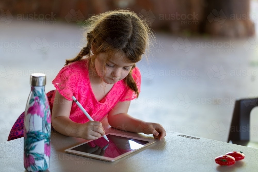little girl drawing on digital tablet - Australian Stock Image