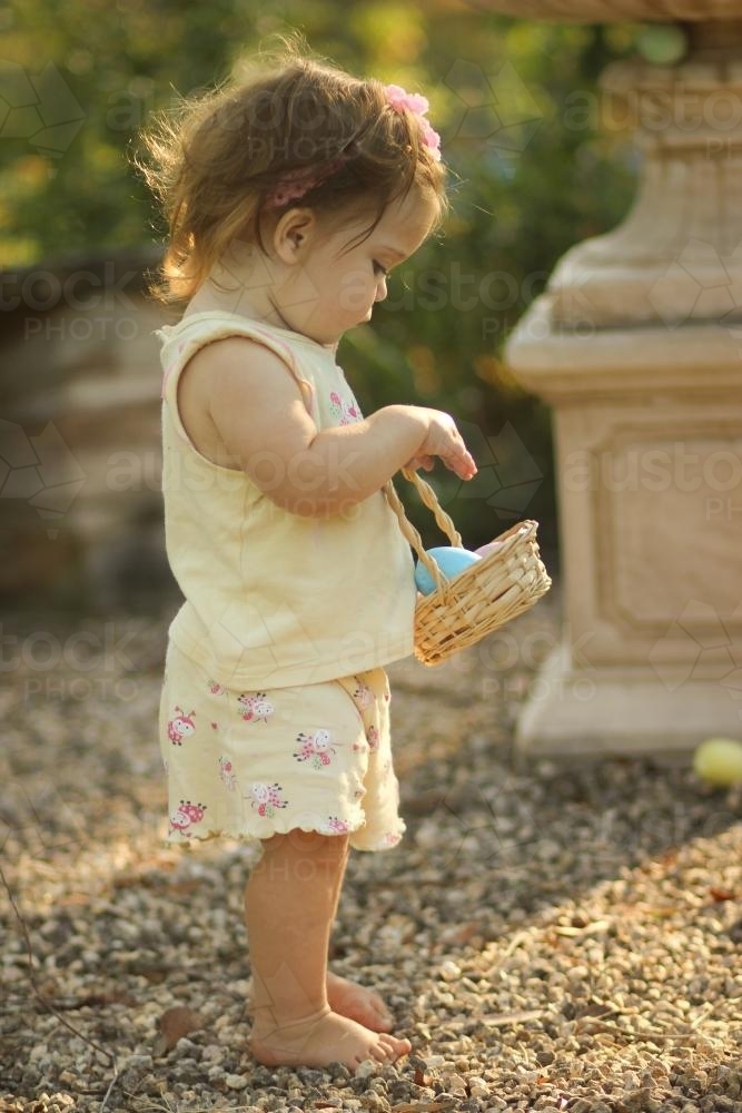 Little girl easter egg hunting - Australian Stock Image