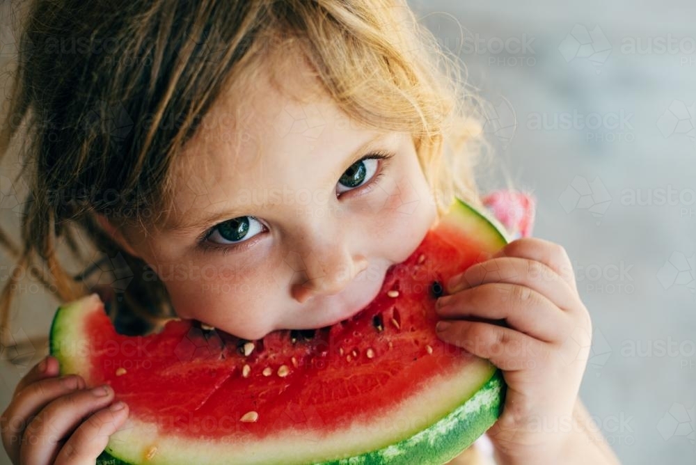 Little girl eating watermelon - Australian Stock Image