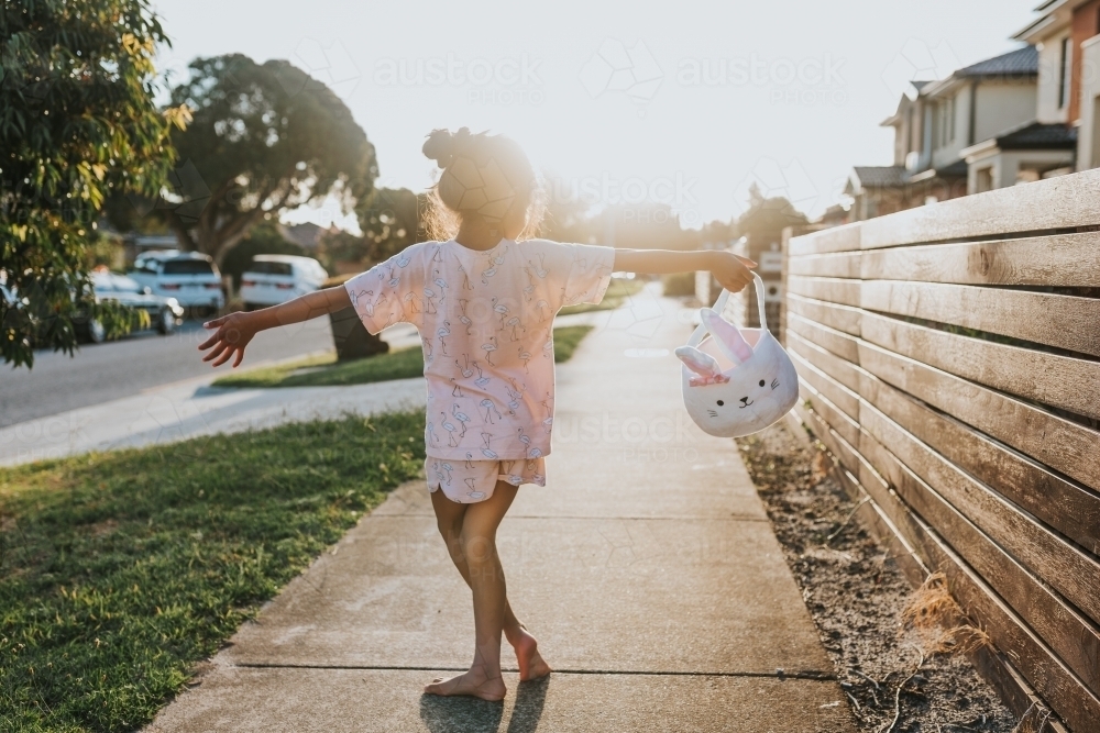 little girl holding Easter bunny basket - Australian Stock Image