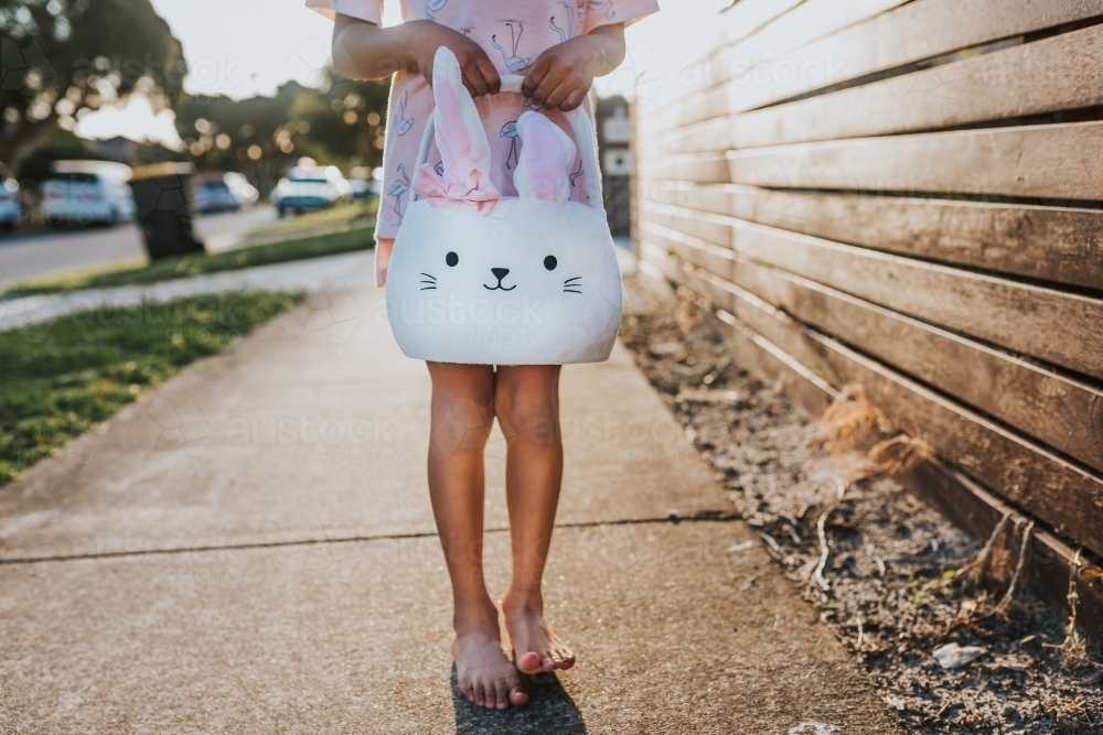 Little girl holding Easter bunny basket - Australian Stock Image