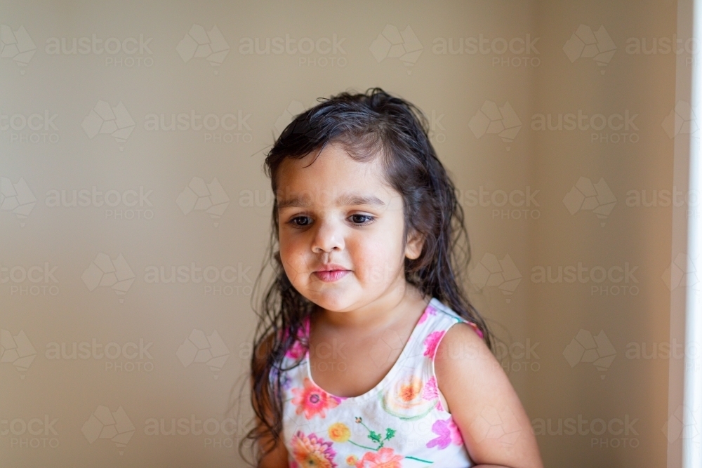 Little girl in house with bare walls - Australian Stock Image
