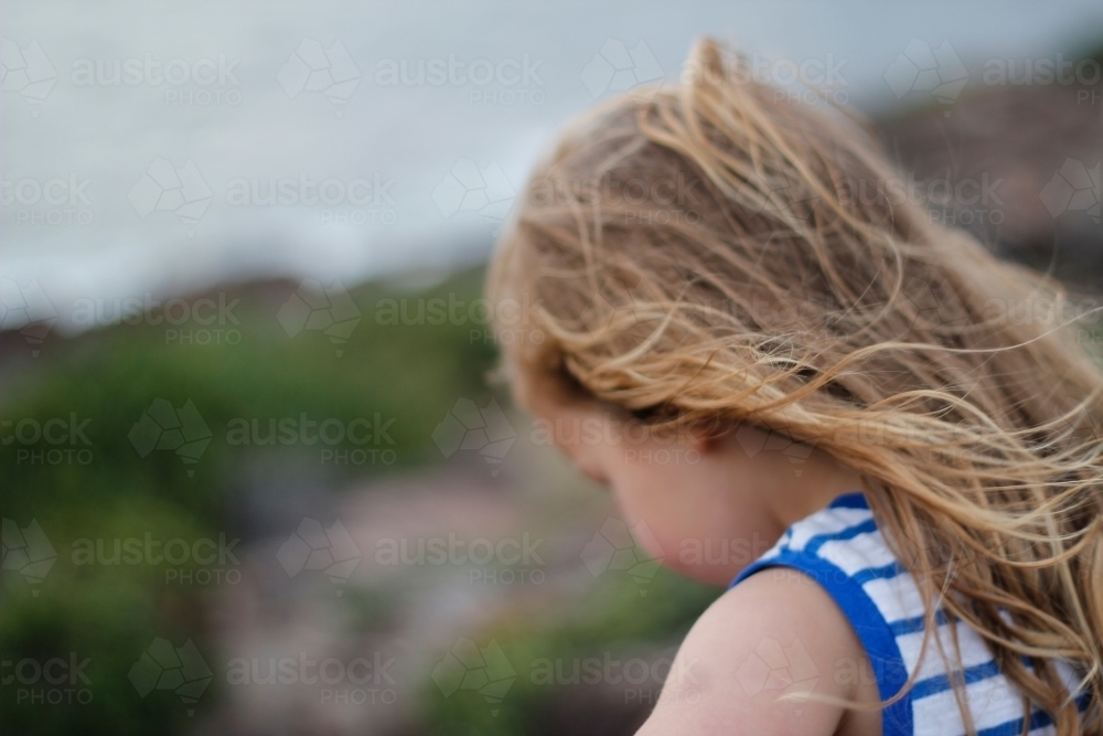 Little girl looking from a lookout to the ocean - Australian Stock Image