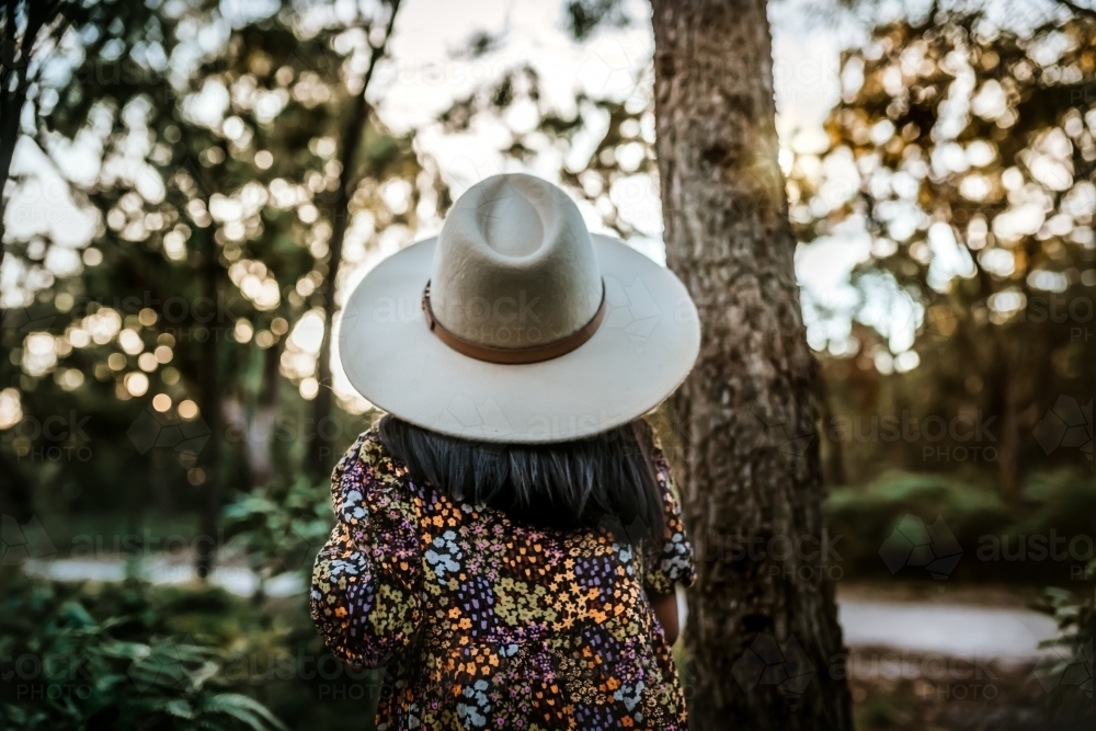 Little girl looking up wearing summer hat - Australian Stock Image