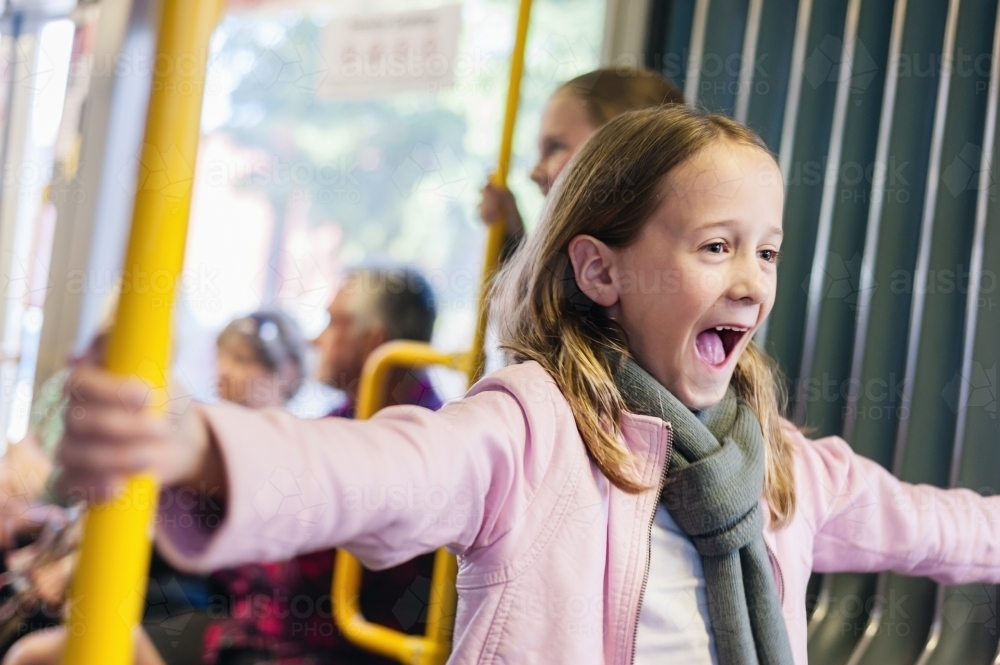 little girl on tram laughing - Australian Stock Image