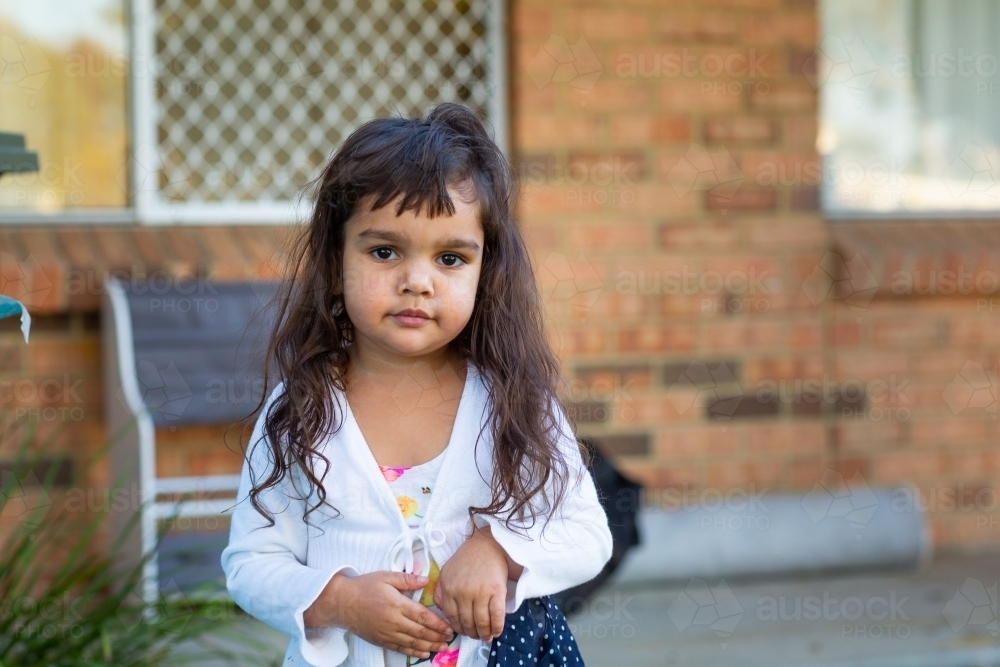 Little girl outside her home - Australian Stock Image