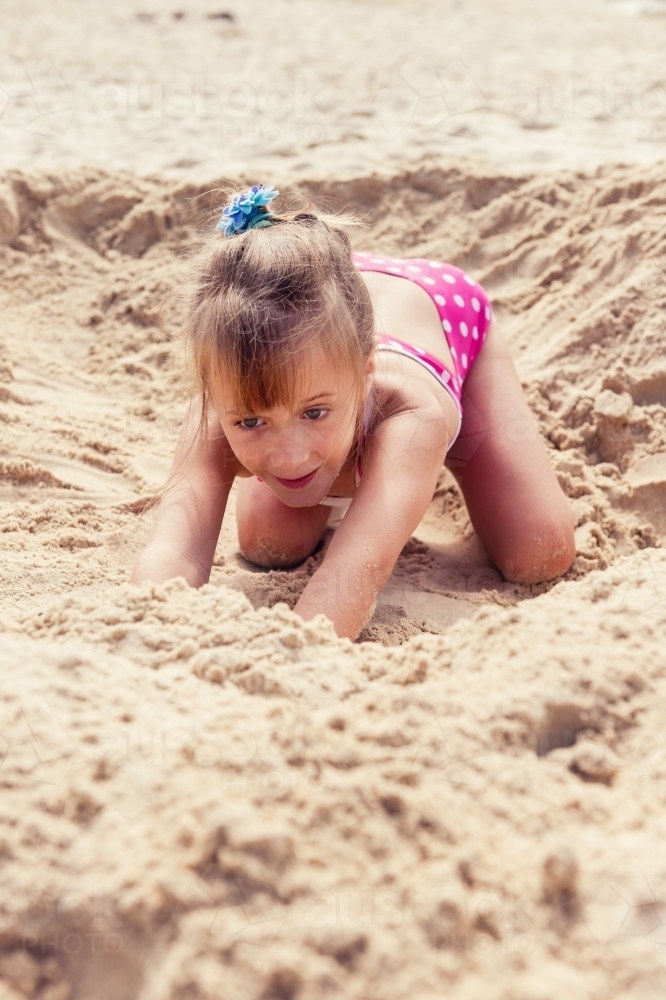little girl playing in the sand at the beach - Australian Stock Image