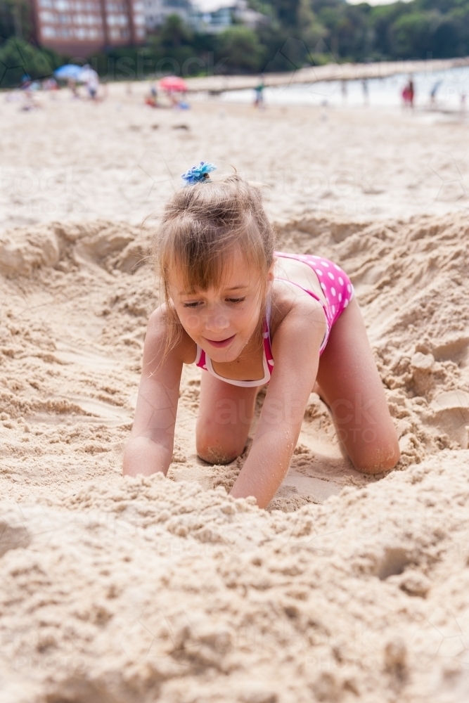 little girl playing in the sand at the beach - Australian Stock Image