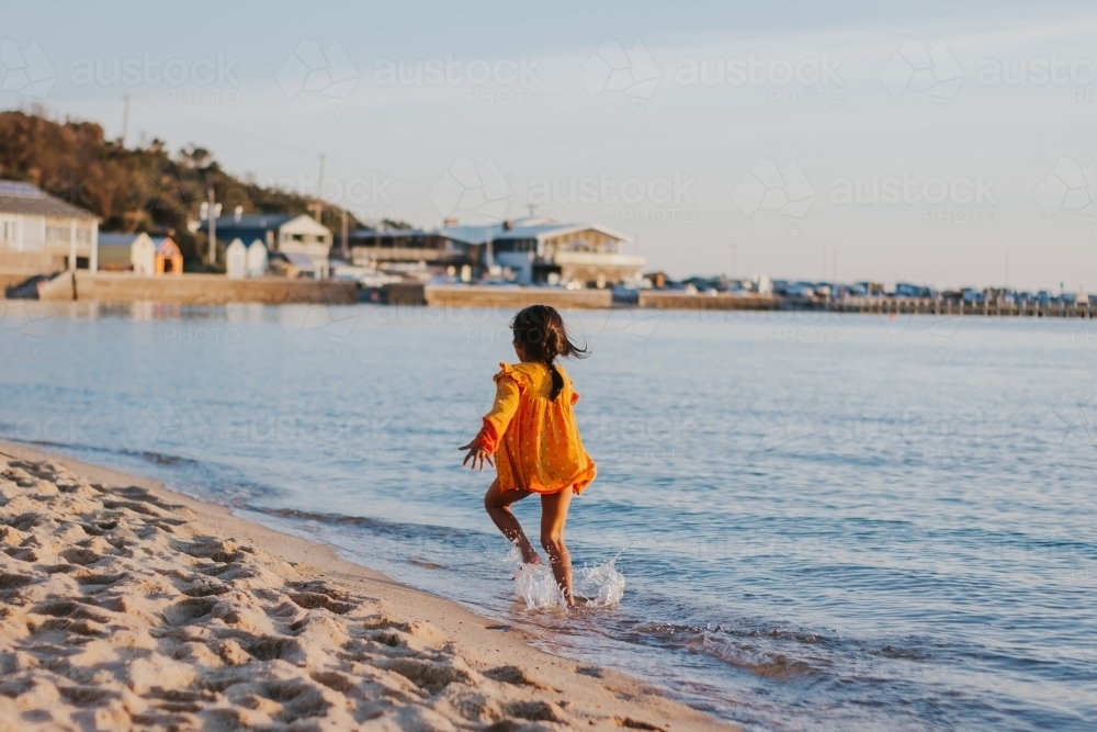 Little girl running at the beach - Australian Stock Image