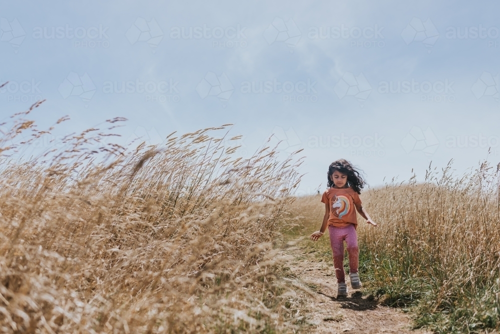 Little girl walking on a coastal path - Australian Stock Image