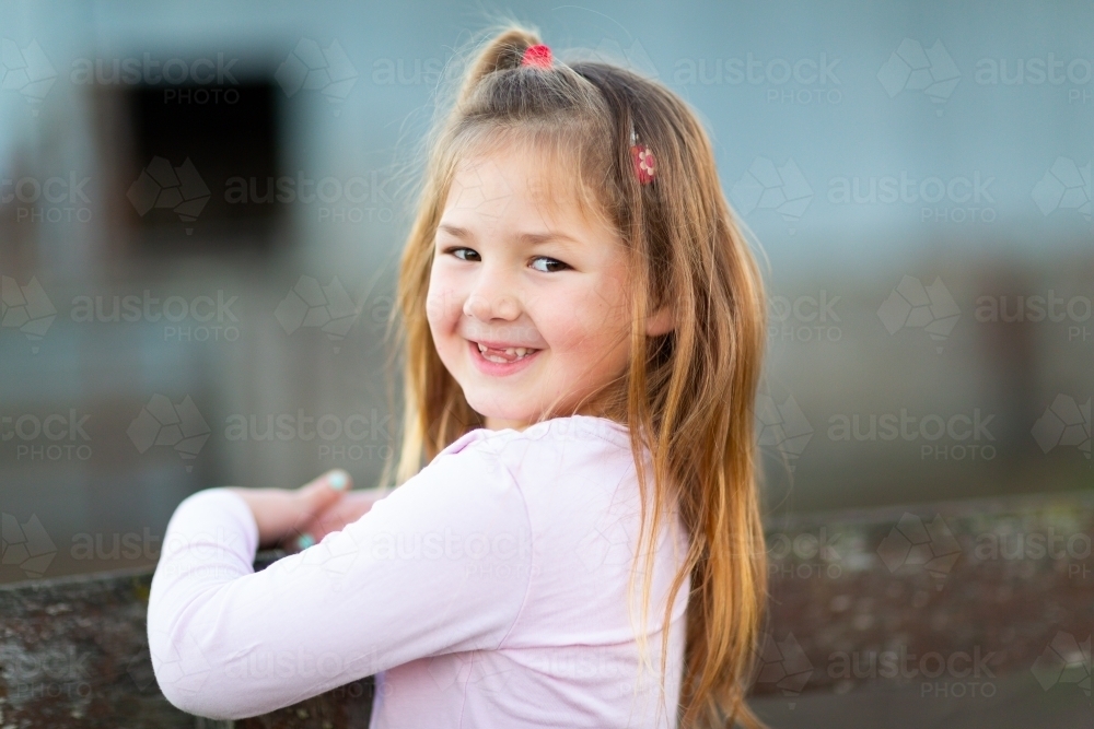 Little girl with long hair and no front teeth - Australian Stock Image