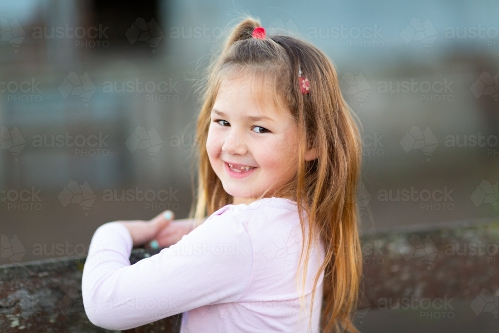 Little girl with long hair and no front teeth - Australian Stock Image