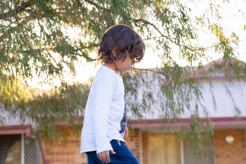 Little kid in profile outside - Australian Stock Image