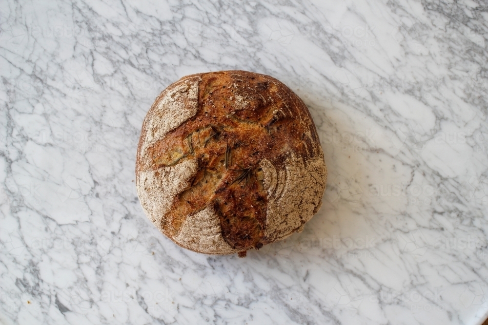 Loaf of bread on marble bench top - Australian Stock Image