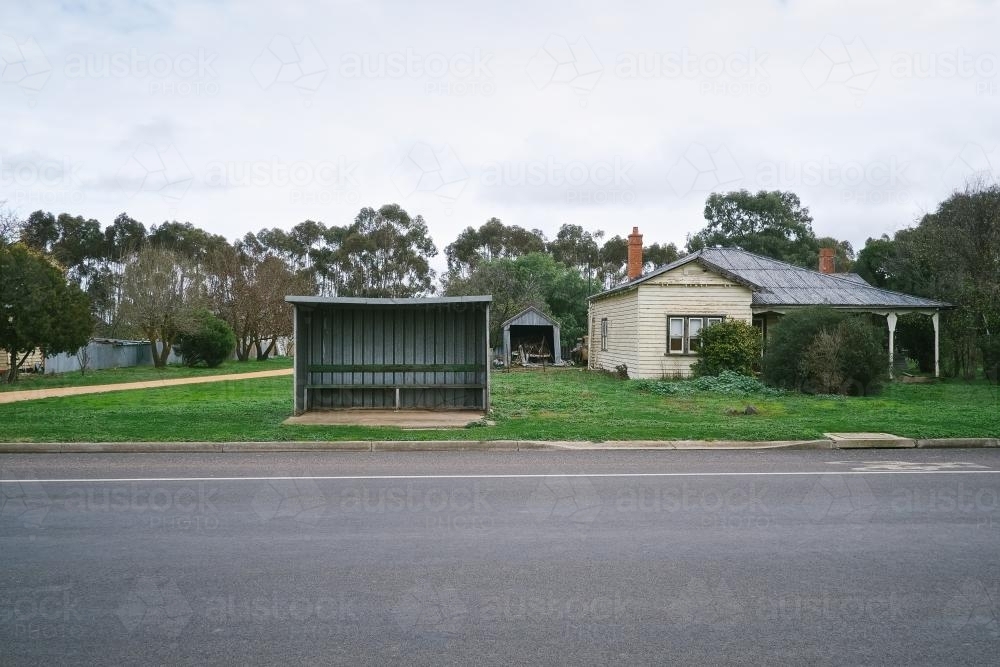 Local bus stop beside a house in regional township - Australian Stock Image
