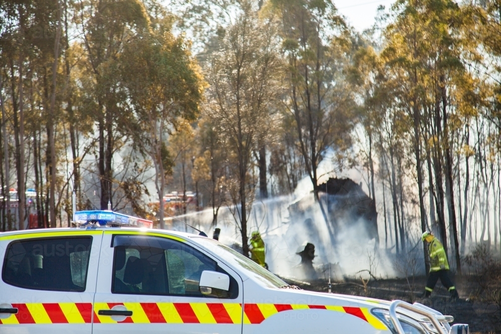 Local fire brigade emergency vehicle parked beside bushfire and firemen - Australian Stock Image