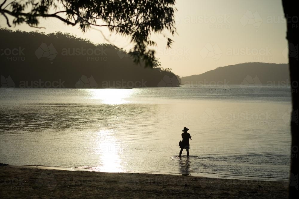 Lone fisherman at Sunset - Australian Stock Image