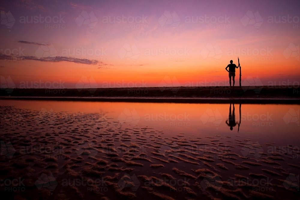 Lone tribal silhouette at sunset - Australian Stock Image