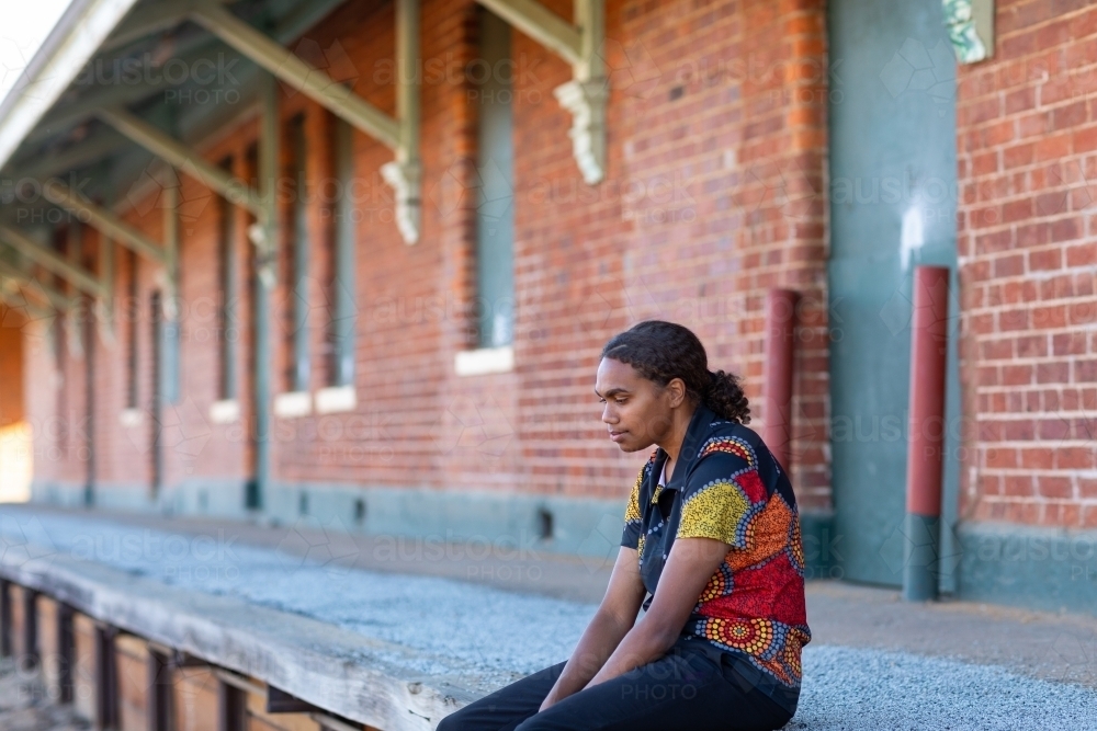 lonely figure on disused railway platform - Australian Stock Image