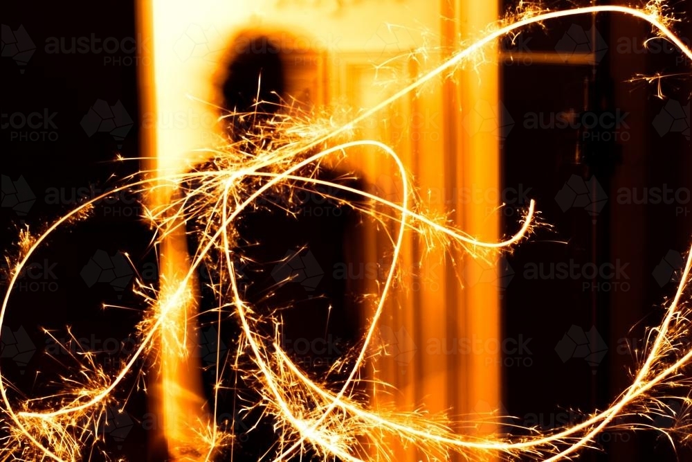 Long exposure of a sparkler being waved at a celebration - Australian Stock Image
