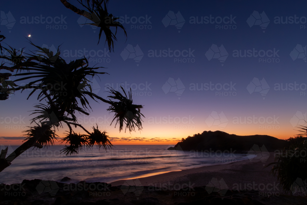 Long exposure of dawn over the ocean, beach, and headland - Australian Stock Image