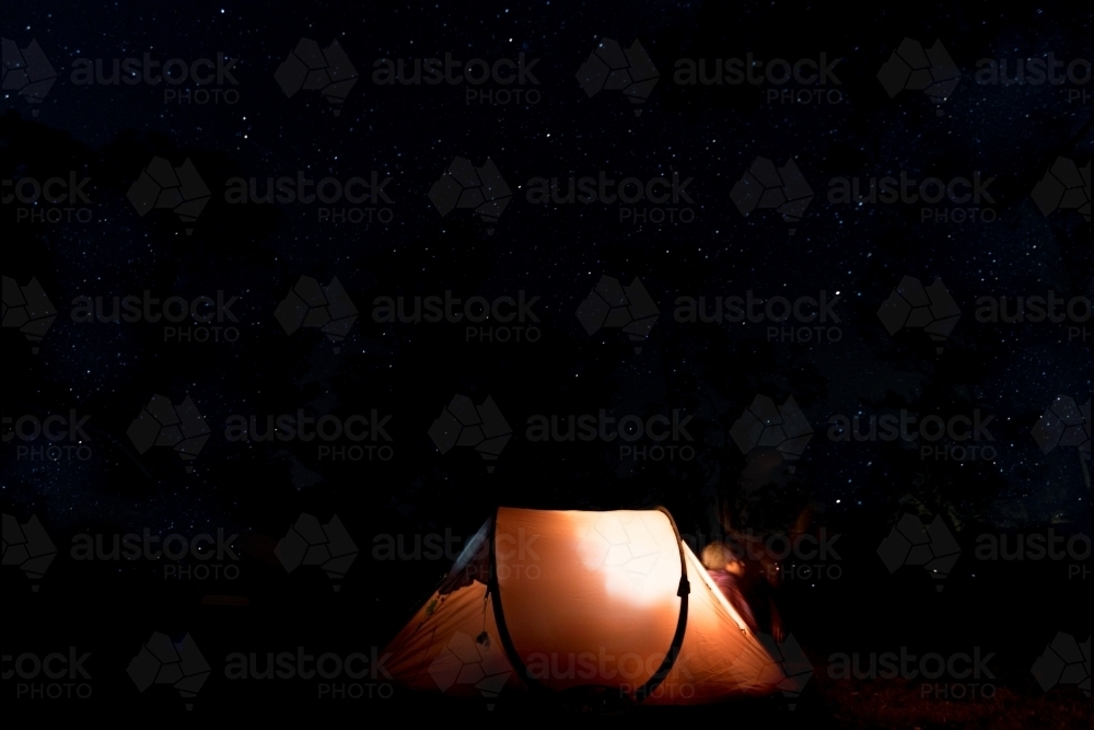 Long exposure of night sky with tent in forground - Australian Stock Image