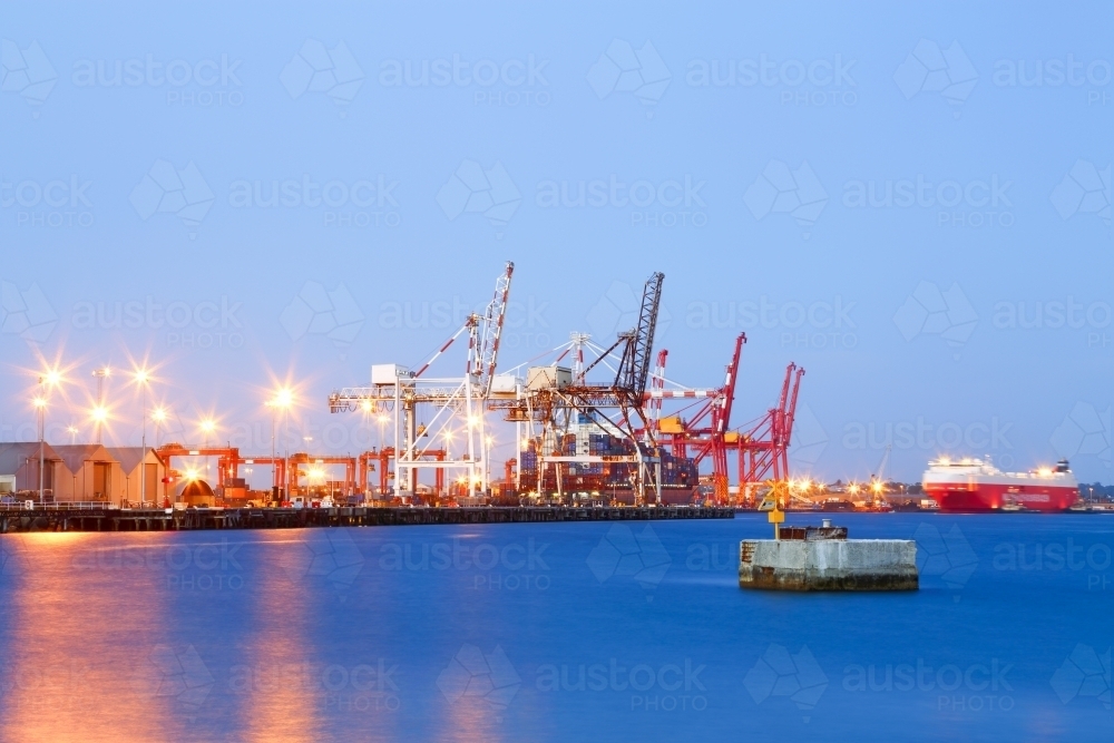 Cargo ship and cranes at a sea port. - Australian Stock Image