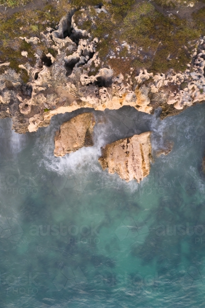Long exposure of waves on limestone cliffs at the Henderson Cliffs - Australian Stock Image