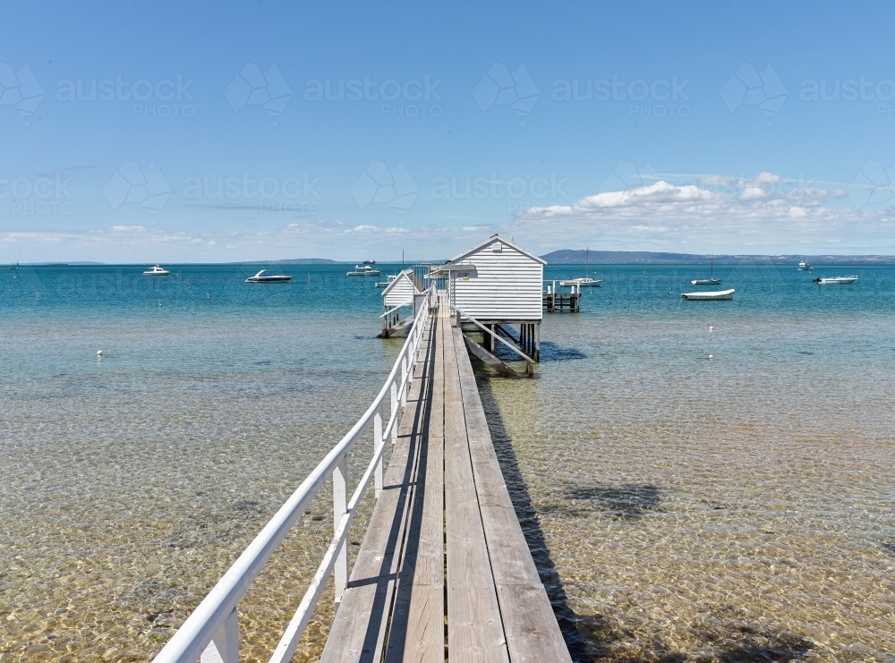 Long jetty leading to a boat shed - Australian Stock Image