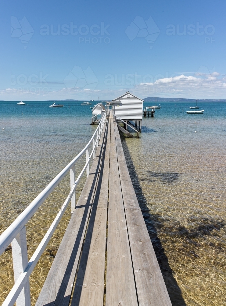 Long jetty leading to a boat shed - Australian Stock Image