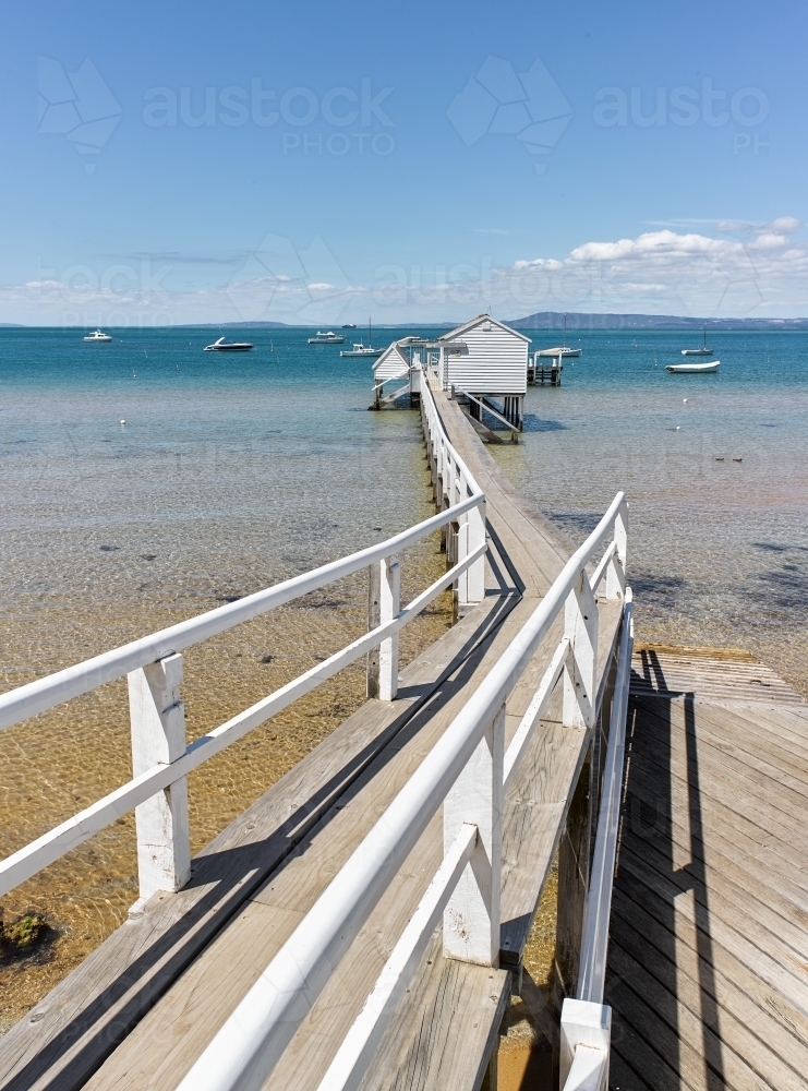 Long jetty leading to boat shed - Australian Stock Image