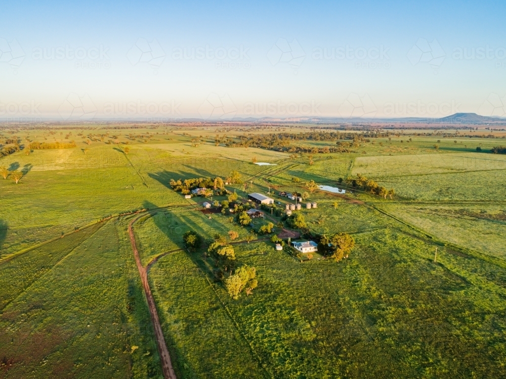 Long shadows of farm homesteads and green paddocks - Australian Stock Image