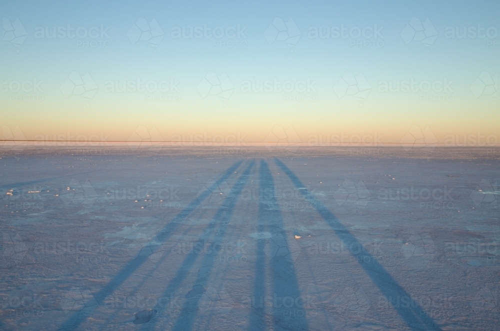 long shadows on salt lake - Australian Stock Image
