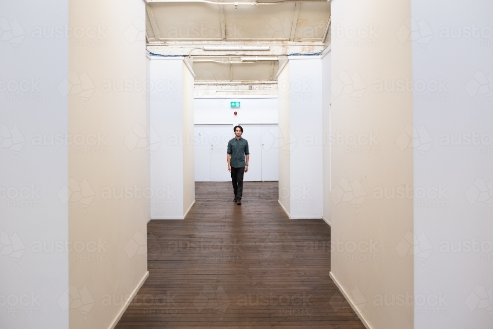Long shot of a man in a renovated urban building - Australian Stock Image