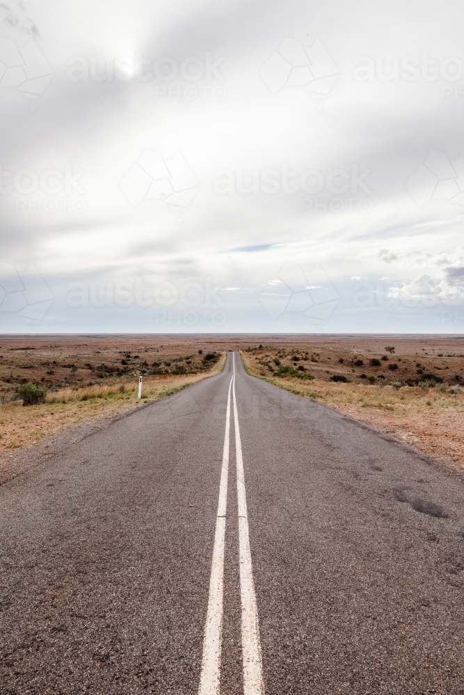 Long straight road with double unbroken lines till the horizon - Australian Stock Image