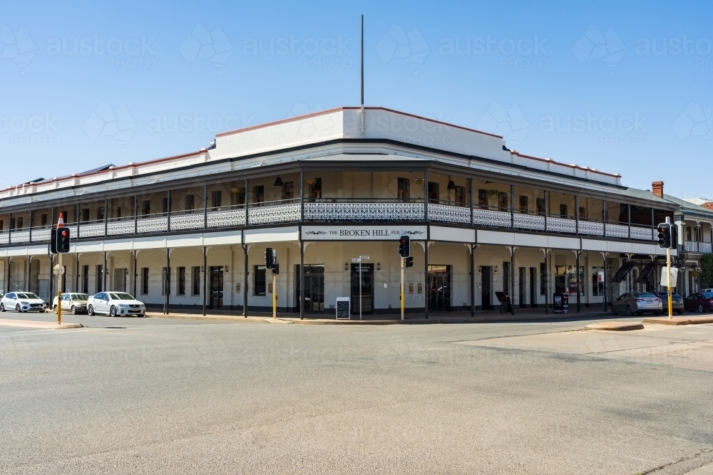 Looking across an intersection at a large regional hotel with a balcony and veranda all round - Australian Stock Image