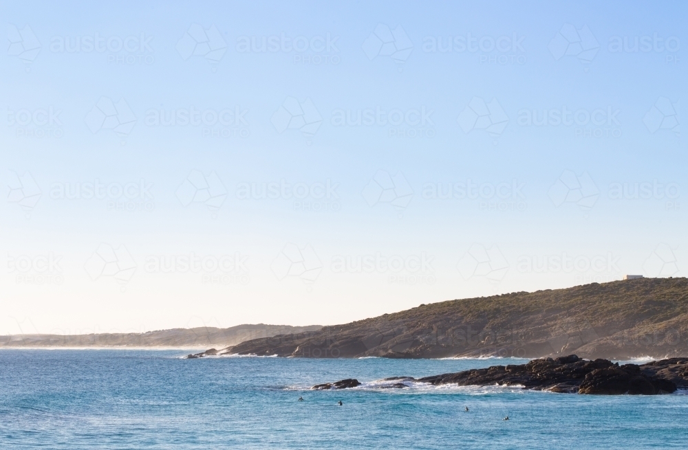 looking across Native Dog to Dillon Bay with distant surfers - Australian Stock Image