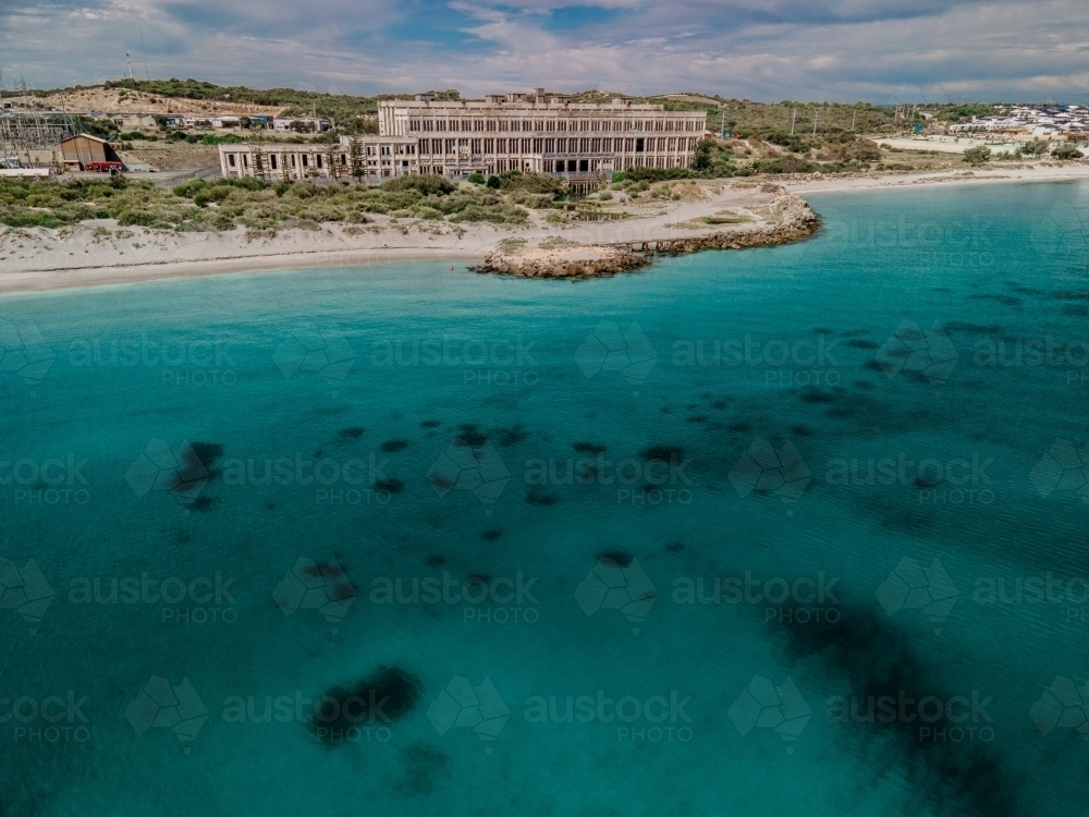 Looking across the ocean at abandoned power station - Australian Stock Image